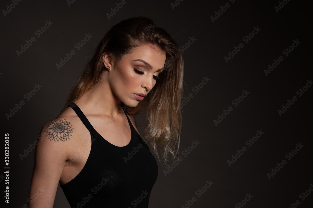 Beauty portrait of a gorgeous young woman over dark background Beauty portrait of a gorgeous young woman over dark background