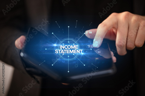 Businessman holding a foldable smartphone with INCOME STATEMENT inscription, new business concept