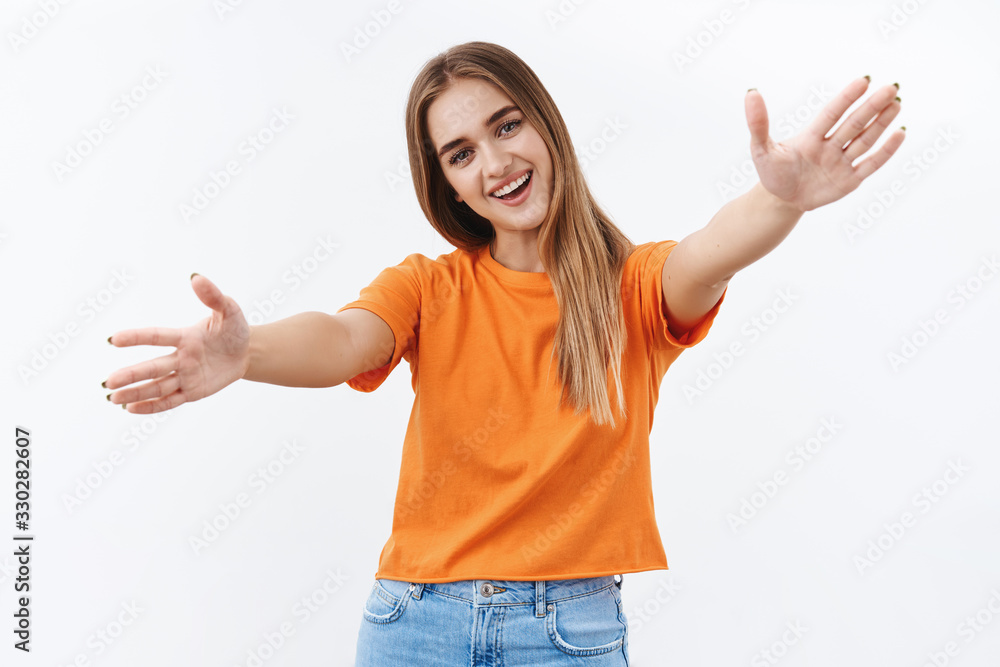 Cute blond girl inviting you for hug, extend hands in warm welcome, smiling and tilt head lovely looking camera, cuddling dear friend, reaching for embraces, standing white background Cute blond girl inviting you for hug, extend hands in warm welcome, smiling and tilt head lovely looking camera, cuddling dear friend, reaching for embraces, standing white background