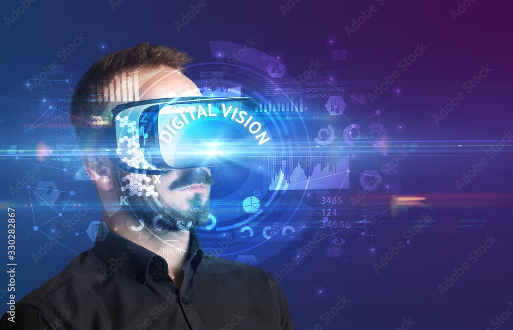 Businessman looking through Virtual Reality glasses with DIGITAL VISION inscription, innovative technology concept Businessman looking through Virtual Reality glasses with DIGITAL VISION inscription, innovative technology concept