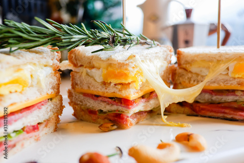 Club sandwich with ham, tomato and cheese