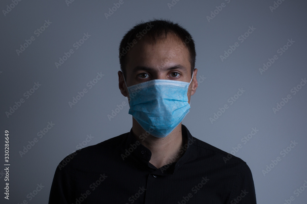 Strong man wearing mask to prevent flu virus and dust air pollution on white background Strong man wearing mask to prevent flu virus and dust air pollution on white background