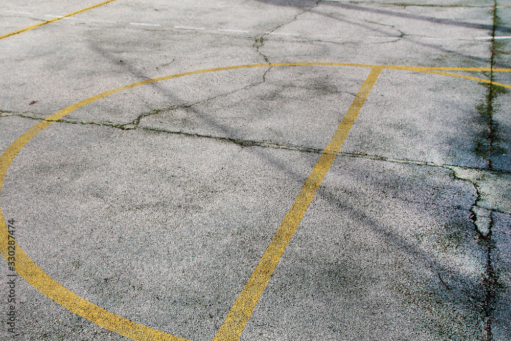 Gray asphalt with yellow lines on urban soccer field Gray asphalt with yellow lines on urban soccer field