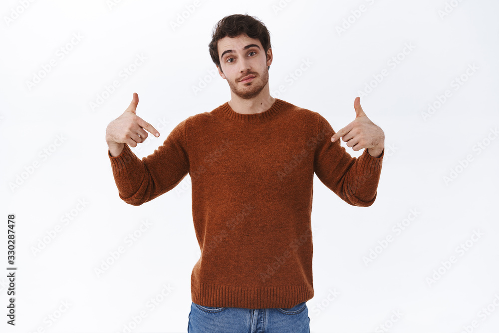 Cool and confident handsome bearded man pointing fingers down and look assured camera, recommend event tickets, promotion of store or corporate banner, advertisement concept, white background Cool and confident handsome bearded man pointing fingers down and look assured camera, recommend event tickets, promotion of store or corporate banner, advertisement concept, white background