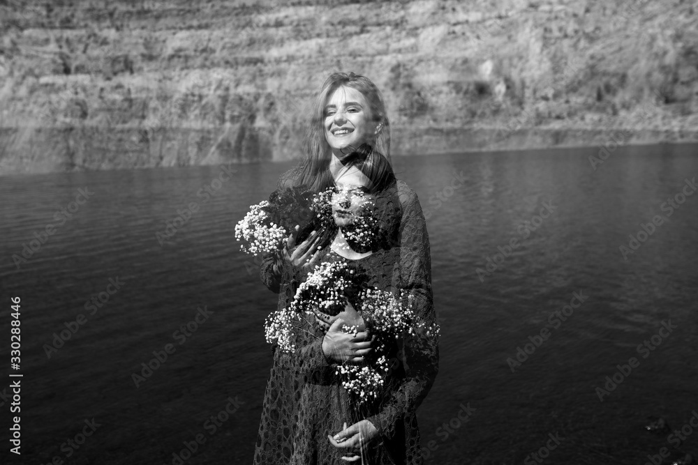 Double exposure portrait of beautiful young woman holding bouquet of flowers . Outdoors portrait, lake in background. Double exposure portrait of beautiful young woman holding bouquet of flowers . Outdoors portrait, lake in background.