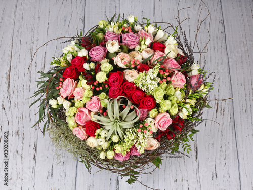 Flower arrangement with roses, lilac and tillandsia xerographica photo