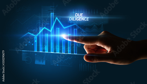 Hand touching DUE DILIGENCE button, business concept
