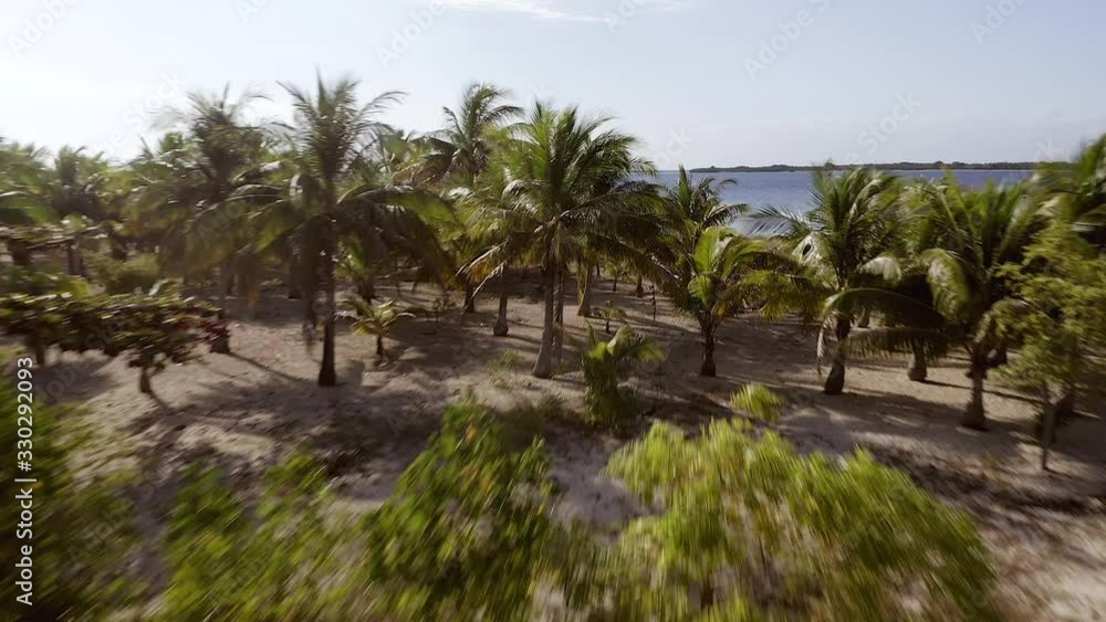 Aerial low pass over Pulau Bedil, a tiny Indonesian beautiful island off the coat of Lombok. Aerial low pass over Pulau Bedil, a tiny Indonesian beautiful island off the coat of Lombok.