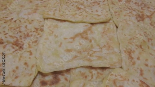 closeup of fresh baked Moroccan square pancakes called Rghaif or Msemen photo