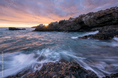 A beautiful golden seascape photographed on a stormy day at sunset in Hermanus  South Africa.