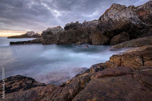 A beautiful early evening seascape photographed on a stormy day after sunset in Hermanus, South Africa.
