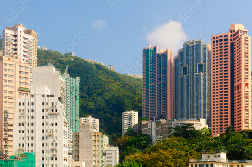Urban skyline with skyscrapers on a hill.
