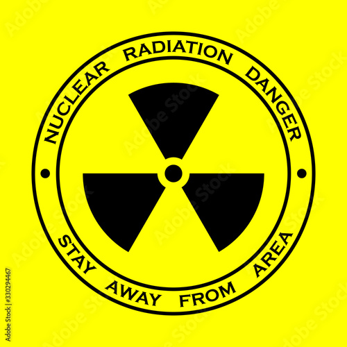Black sign for nuclear radiation on yellow background, with warning text around the shape