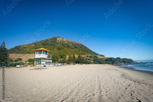 MOUNT MAUNGANUI, NEW ZEALAND - MARCH 6, 2020: The Surf Lifesaving tower stands ready on the Mount Main Beach on a beautiful sunny blue sky Autumn day
