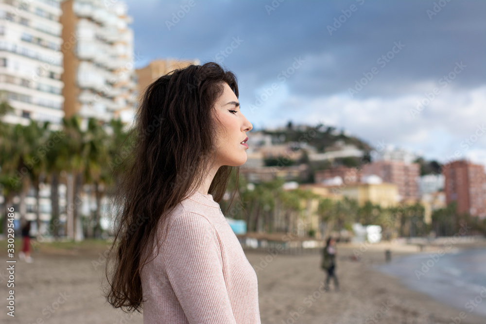 Young woman relaxing on the beach enjoying a nice sunny day Young woman relaxing on the beach enjoying a nice sunny day