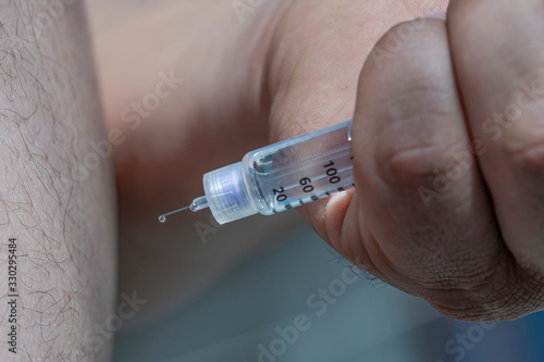 Diabetes. Diabetes treatment A diabetes patient injects himself with insulin. Insulin syringe pen. A drop of insulin at the end of the needle. Macro shooting