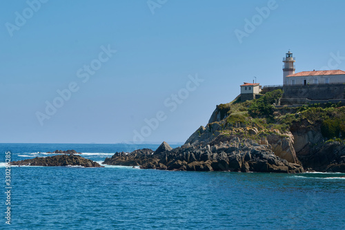 Ocean coast with lighthouse and cliff