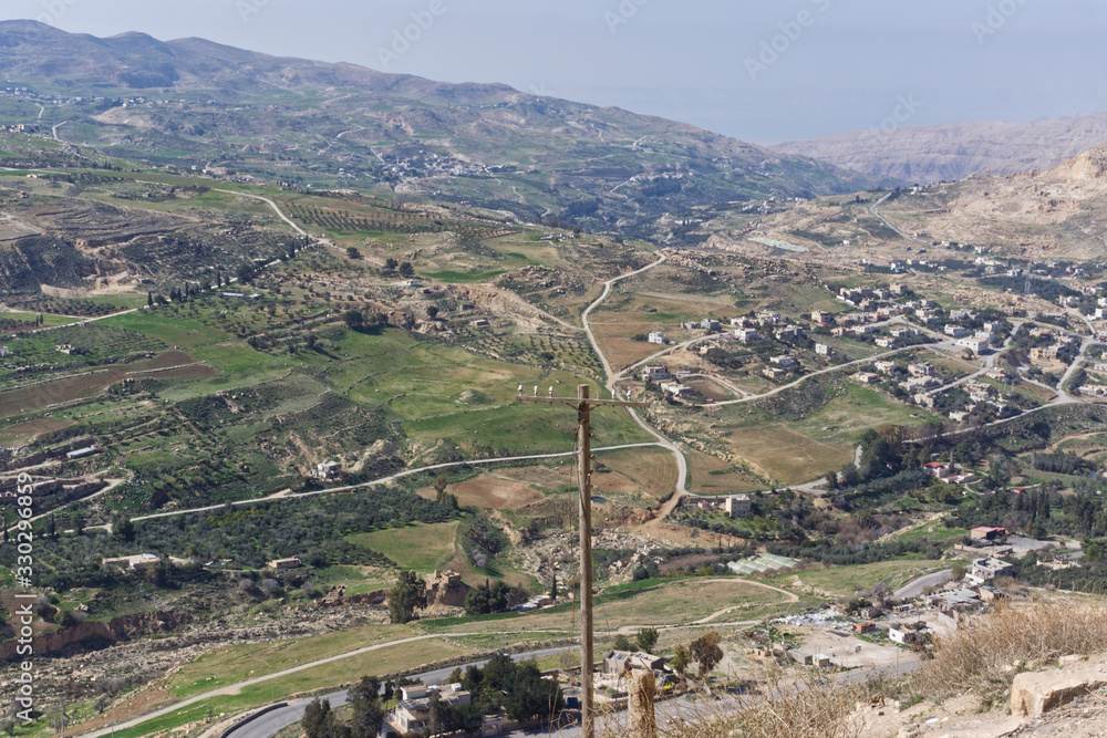 Landscape view of the city of Al Kerak in  Jordan in the Spring with lush countryside and olive groves