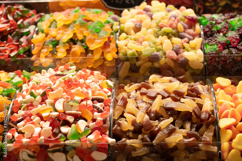 Candies of different types and colors close up. Photographed in front of the store.