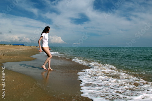 Girl in a white t- shirt near the sea