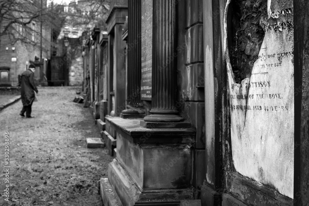 An spooky black and white photograph taken in the graveyard close to the Edinburgh castle in Scotland. An spooky black and white photograph taken in the graveyard close to the Edinburgh castle in Scotland.