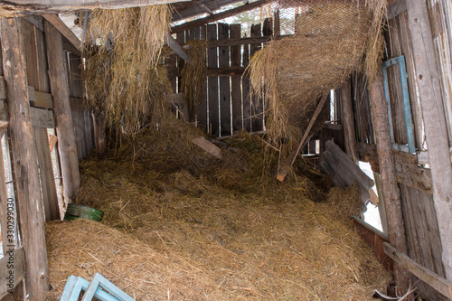 Old hayloft. Rickety logs and boards. Dry grass.