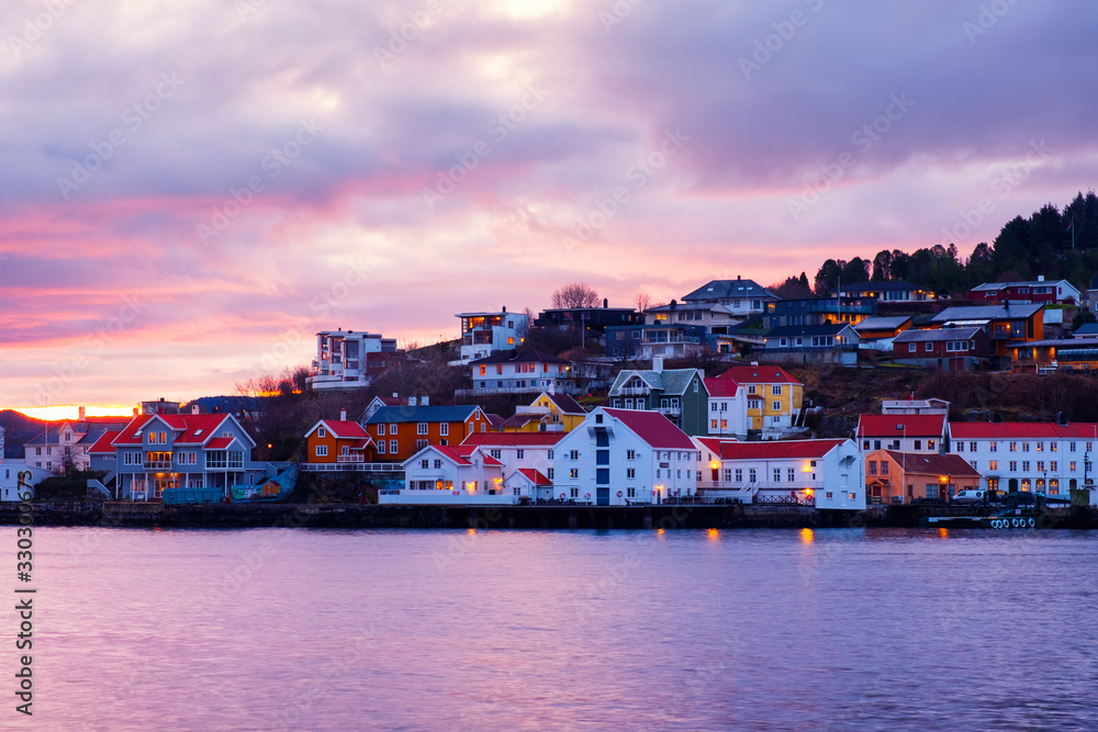 View of city center of Kristiansund, Norway during the cloudy morning at sunrise with colorful sky