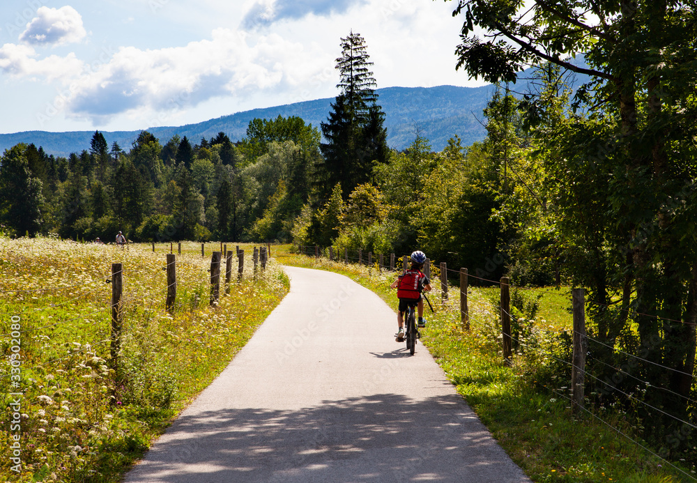 Fototapeta premium Child on a bicycle at countryside track