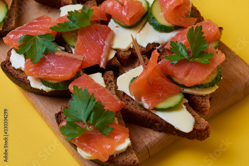 Sandwiches with red fish. Sandwiches with trout or salmon, butter and cucumber.