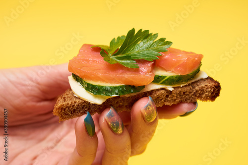Sandwiches with red fish. Sandwiches with trout or salmon, butter and cucumber.