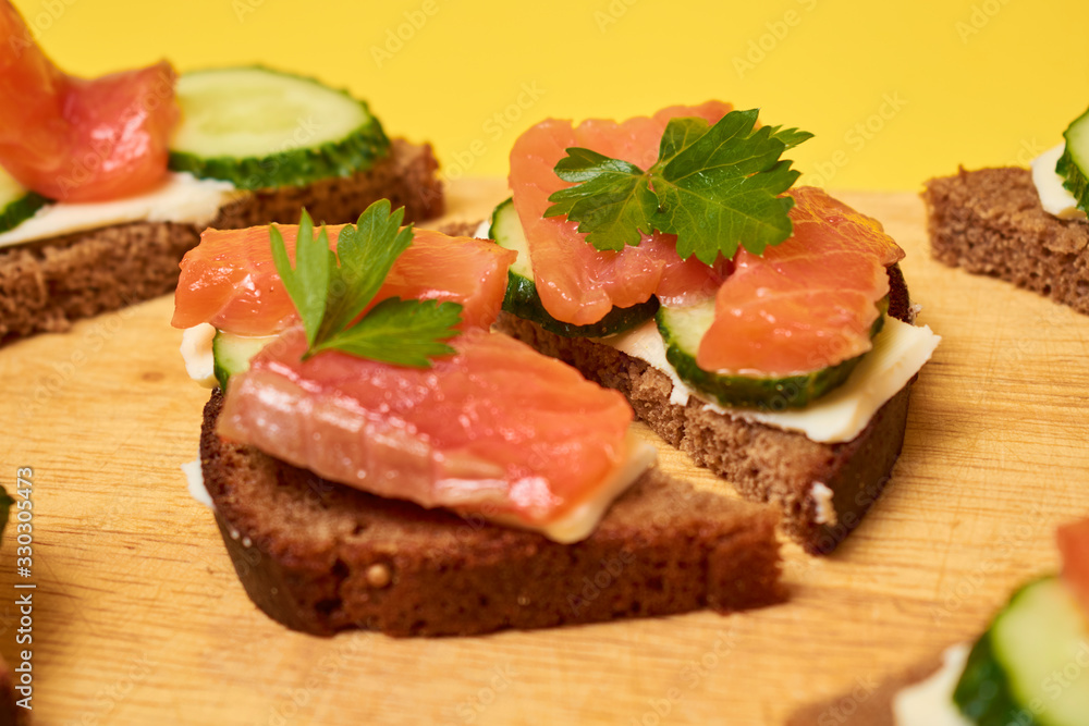 Red Trout Fish. Sandwiches with red fish. Sandwiches with trout or salmon, butter and cucumber.