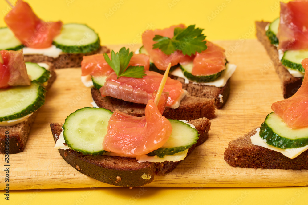 Red Trout Fish. Sandwiches with red fish. Sandwiches with trout or salmon, butter and cucumber.