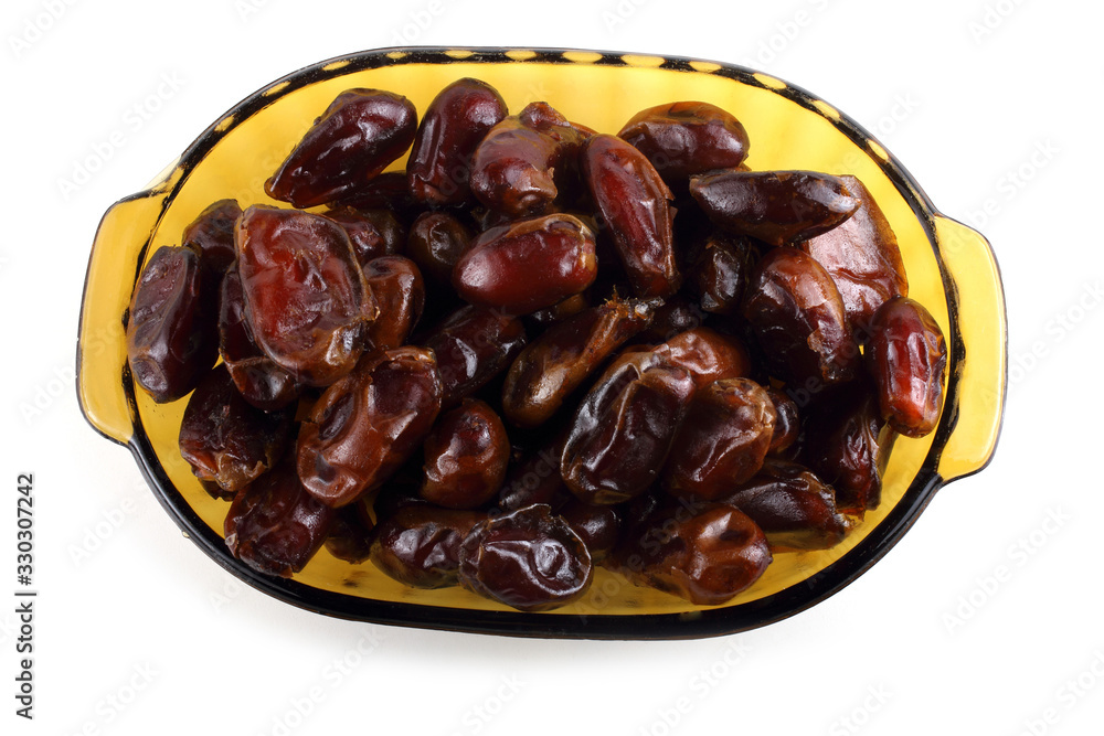 Date fruits on plate isolated on white Date fruits on plate isolated on white