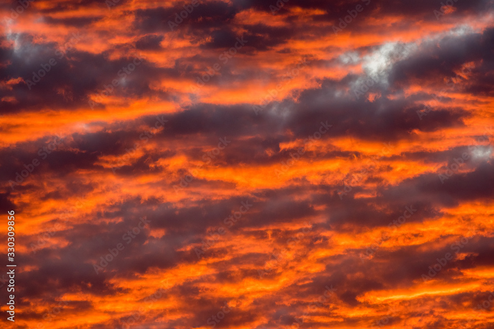 A beautiful close up of textured clouds, glowing red and orange in the setting sun, taken on the Chobe River in Botswana.