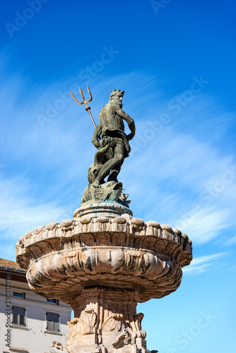 The Neptune fountain in Cathedral square (Piazza del Duomo) with the bronze statue of the Roman God with the trident. Trento downtown, Trentino-Alto Adige, Italy, Europe