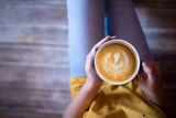 girl holding a cup of coffee - coffee art concept