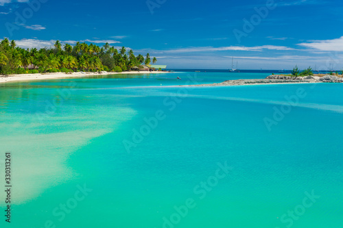 Palm trees on a white sandy beach at Plantation Island, Fiji, South Pacific