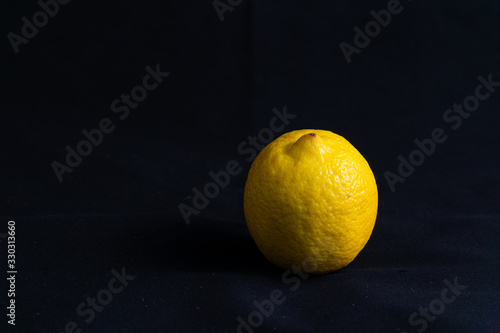 Yellow lemon on black velvet