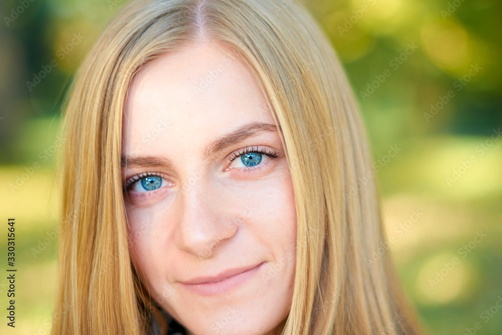 Beautiful young woman is walking in the park. Young woman enjoying nature