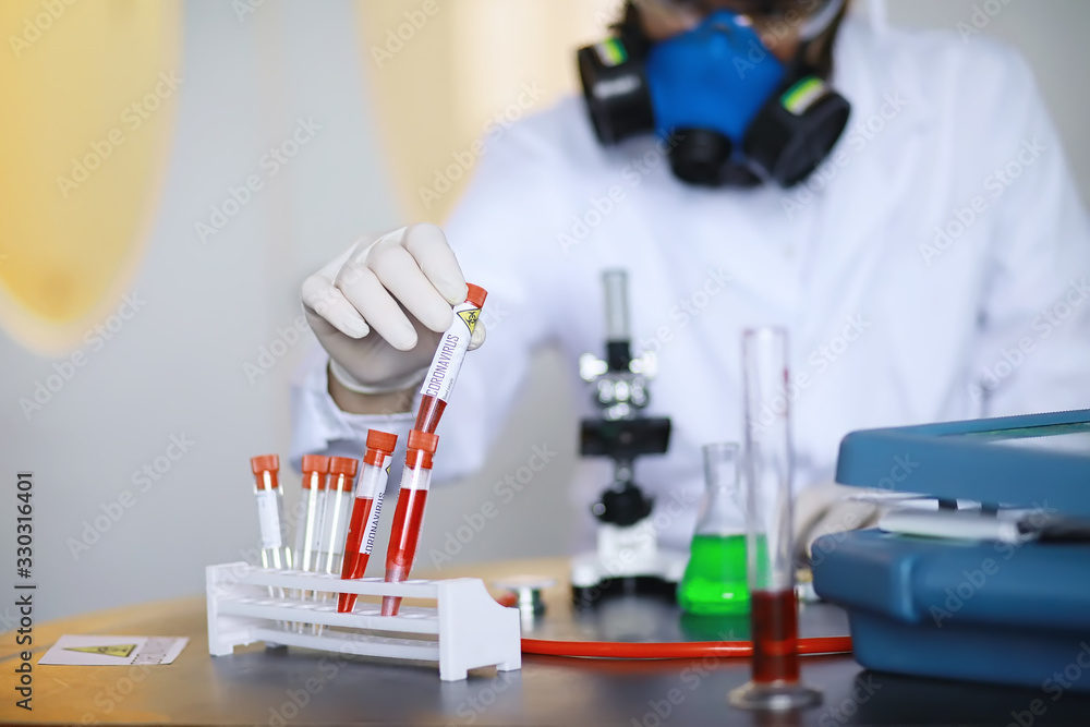 A scientist researcher in the laboratory is testing drugs for the treatment of viral pneumonia. Coronovirus blood test of infected patients. World pandemic. A scientist researcher in the laboratory is testing drugs for the treatment of viral pneumonia. Coronovirus blood test of infected patients. World pandemic.