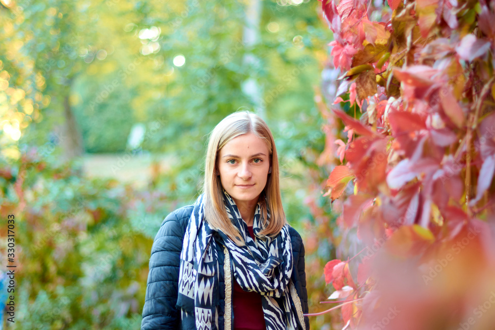 Beautiful young woman is walking in the park. Young woman enjoying nature Beautiful young woman is walking in the park. Young woman enjoying nature
