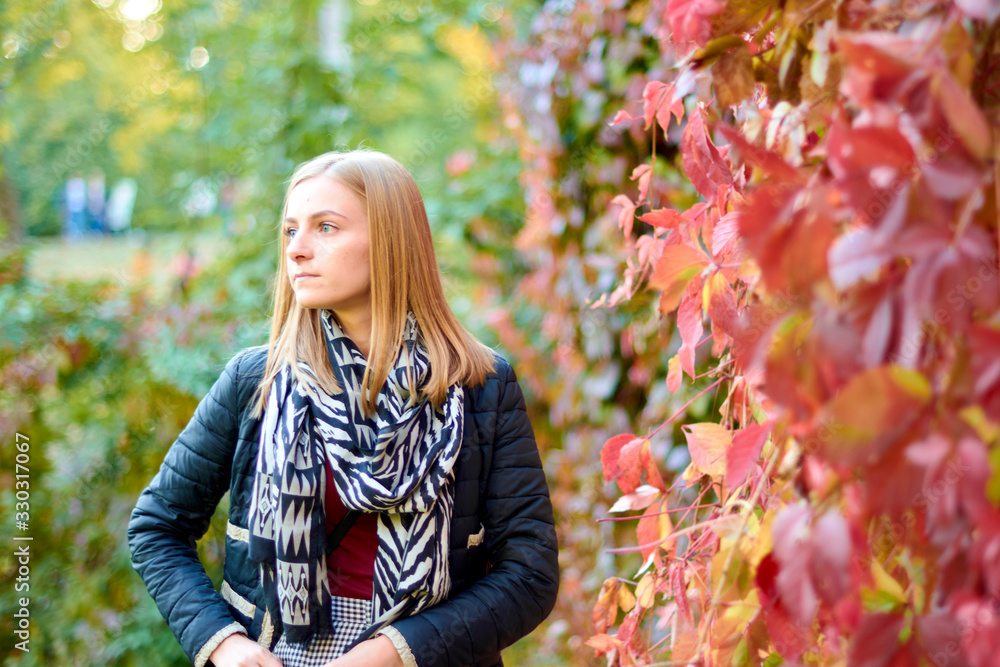 Beautiful young woman is walking in the park. Young woman enjoying nature Beautiful young woman is walking in the park. Young woman enjoying nature