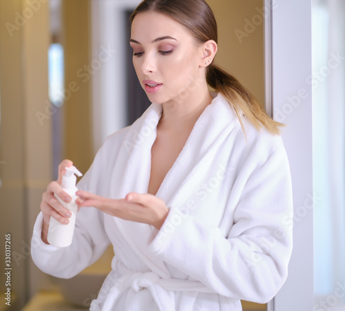 Woman applying an antibacterial antiseptic gel for hands disinfection from bacteria. Health protection during flu virus outbreak, epidemic and infectious diseases © ZoomTeam