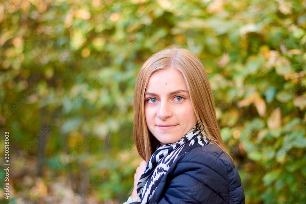 Beautiful young woman is walking in the park. Young woman enjoying nature Beautiful young woman is walking in the park. Young woman enjoying nature