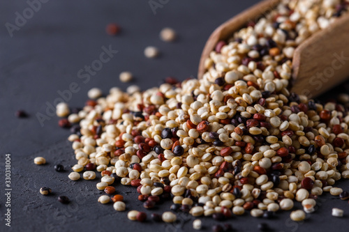 mix of quinoa grains on a dark stone background photo