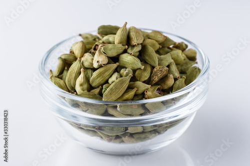 fragrant green cardamom on a white acrylic background