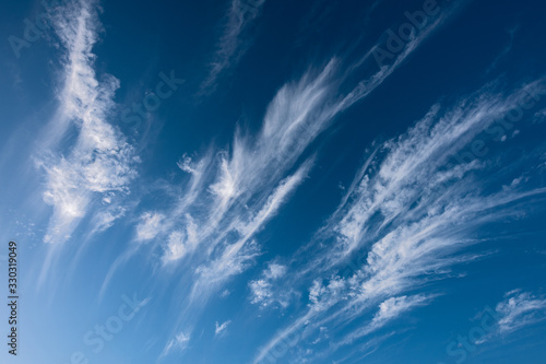 An abstract detail photograph of streaked white clouds against a deep blue sky in the heavens, taken in the Cederberg Mountains, South Africa.