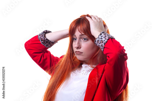 Beautiful confused young woman in red jacket thinking and rubbing hair.