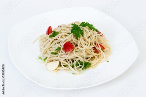 Pasta with vegetables on a plate on a white background