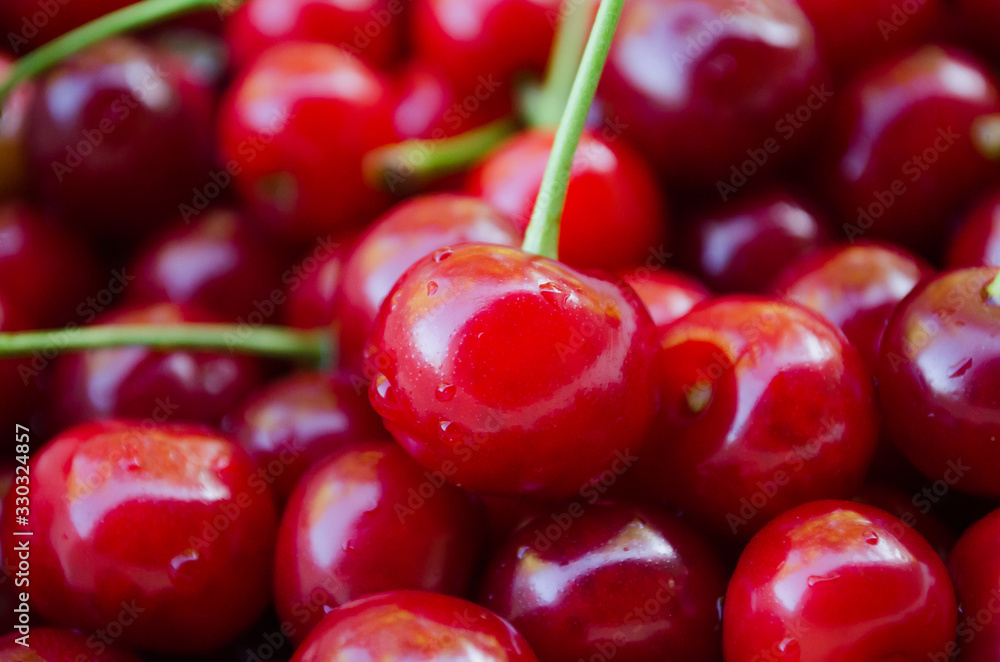 Cherry on a background of greenery. Cherries on a background of cherries. Organic products. Vegetables and fruits. Red ripped cherry. Fruit. Texture and background. Garden and cottage. Nutrition Cherry on a background of greenery. Cherries on a background of cherries. Organic products. Vegetables and fruits. Red ripped cherry. Fruit. Texture and background. Garden and cottage. Nutrition